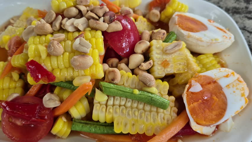 Thai spicy somtum salad close up corn with salted egg Thailand Northeast style food