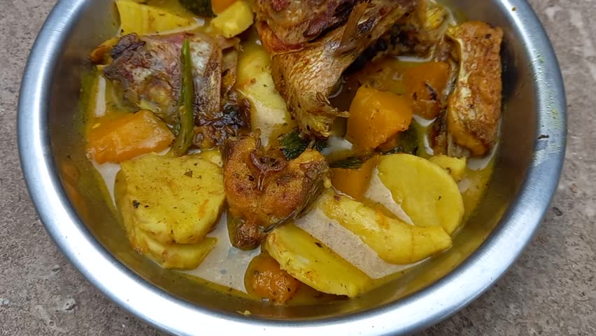 A bowl of fish sour curry, a delicious and flavorful dish.It is presented indoors, emphasizing the comfort of home-cooked meals.