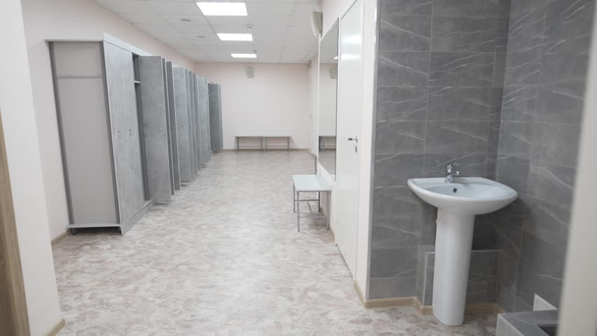 Spacious public shower room completed with convenient storage lockers. Clean surfaces highlight modern sanitary standards and hospitality