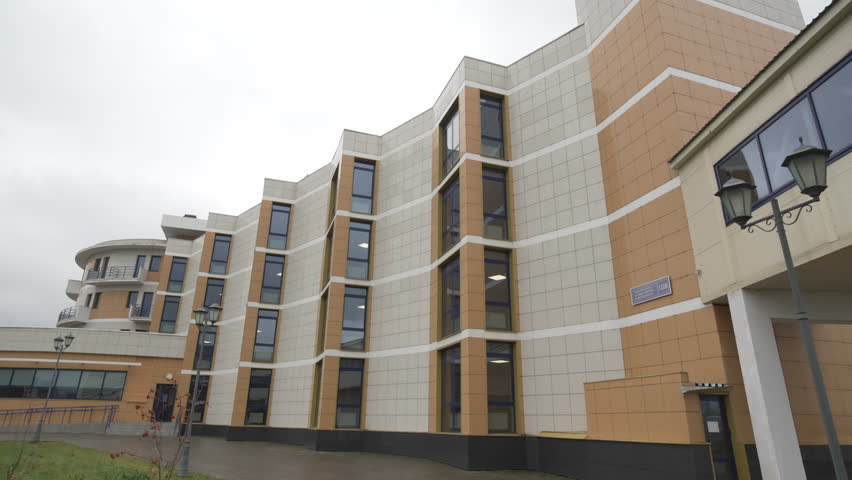 Office building with sharp edges framed by windows. Construction with distinctive angular forms amazes reflecting innovation uniqueness