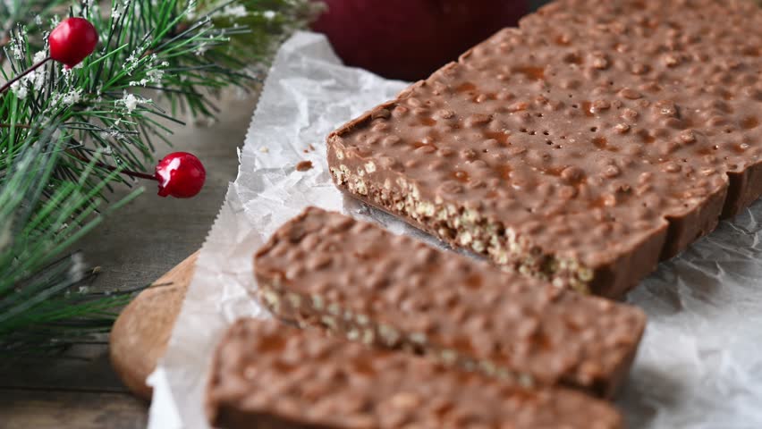 Cutting christmas chocolate nougat. Close up