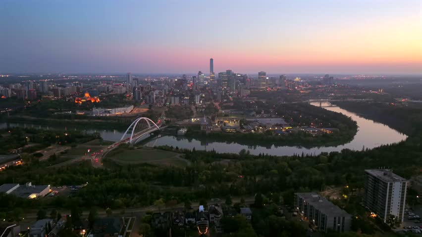 Panoramic aerial sunrise view of downtown Edmonton skyline, Walterdale Bridge, and Alberta Legislature, Alberta, Canada