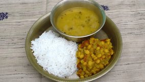 copper plate or thali of steamed rice, dal, and lauki (bottle gourd) sabji, the traditional meal eaten on the first day of Chhath Puja, known as Nahay Khaye. - Powered by Shutterstock - Get 15% off with code: PIKWIZARD15