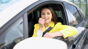 Beautiful young woman applying lip balm in her car, taking a moment to refresh her makeup and flashing a smile at the camera. Attractive female behind the wheel brightening up her look - Powered by Shutterstock - Get 15% off with code: PIKWIZARD15