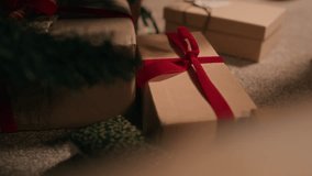 Close up on hand of African American girl child secretly taking wrapped gift box with red bow from under Christmas tree anticipating holiday magic, copy space - Powered by Shutterstock - Get 15% off with code: PIKWIZARD15