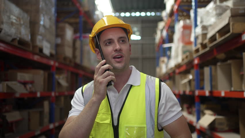 Blue collar worker is working at warehouse. Logistics, transportation.