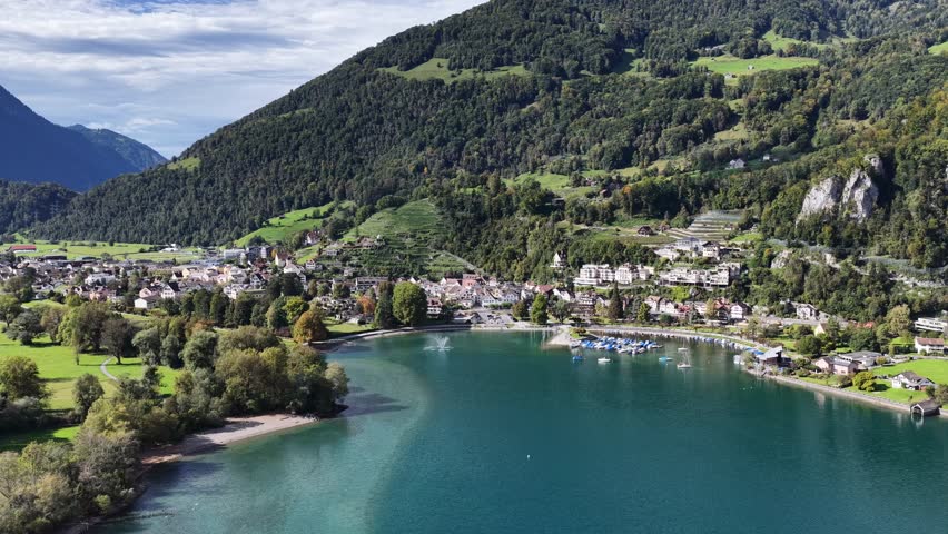 Walenstadt with turquoise Walensee lake and mountain backdrop in Switzerland - Aerial