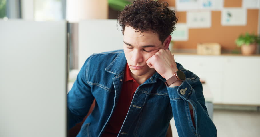 Computer, man and bored with typing in office for burnout, tired and low energy for submission. Internship, lazy journalist and tech with fatigue at desk from insomnia, tedious article and exhausted