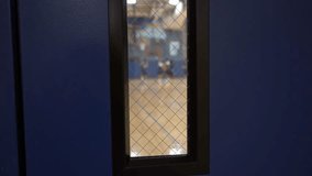 POV of someone looking into a high school gym at sports players - Powered by Shutterstock - Get 15% off with code: PIKWIZARD15
