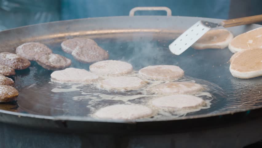 Traditional reindeer meat burgers cooked at Røros Martna. Smoke, flavor, and heritage blend in this cultural winter fair