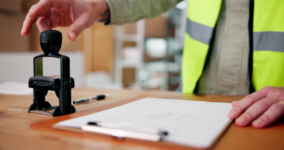 Clipboard, hands and stamp with logistics employee in warehouse for delivery documentation. Paperwork, signature and verification with person in distribution depot for supply chain management