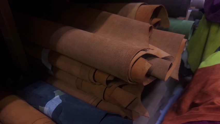 Leather rolls warehouse stocks. Genuine leather and suede. Raw materials to manufacture leather items. Leather rolls storage. 