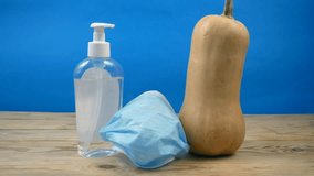 pumpkin wearing a face mask for protection from coronavirus with halloween face. Halloween and virus - Powered by Shutterstock - Get 15% off with code: PIKWIZARD15