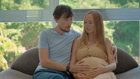 Caring husband supports his pregnant wife as they practice breathing exercises together to ease tension during early labor contractions and prepare for childbirth. Slowmotion video. - Powered by Shutterstock - Get 15% off with code: PIKWIZARD15