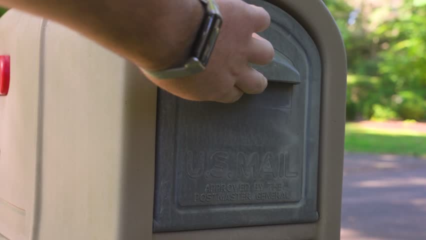 Close up take of opening up an empty mailbox.