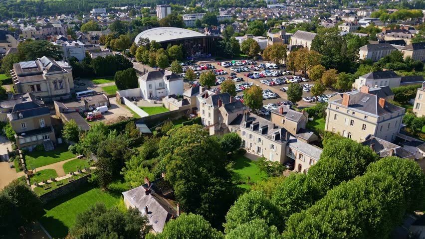 Wide aerial panoramic establishing of Laval multipurpose hall with surrounding urban infrastructure visible