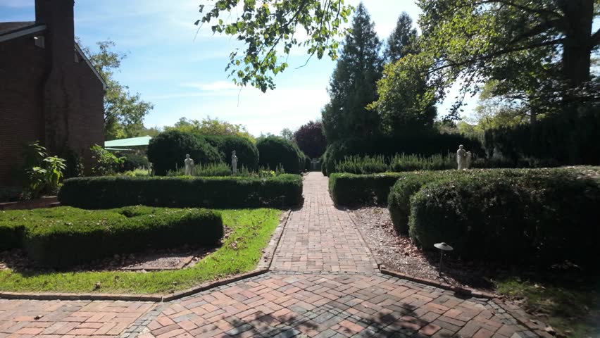 Discover the beautiful gardens at Museum of the Shenandoah in Winchester, Virginia, featuring well-maintained pathways and lush greenery on a cloudy day.