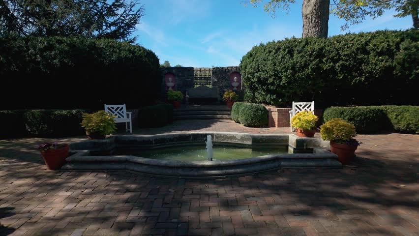 Beautiful gardens at Museum of the Shenandoah showcase lush greenery and a tranquil fountain, perfect for a relaxing stroll in Winchester, Virginia.
