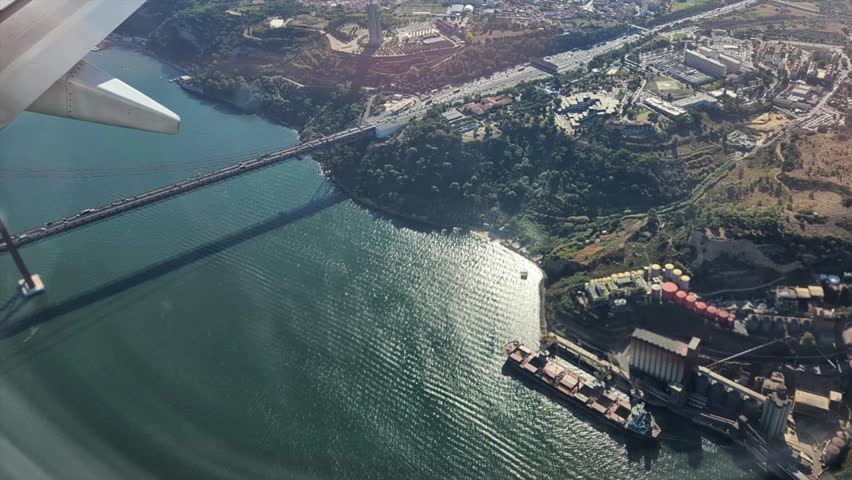 Window plane passenger point of view featuring lisboa and portugal coast aerial photos looped animated video