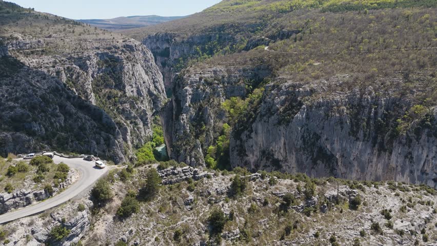 Aerial journey above Verdon Gorge, where rugged mountains meet the emerald river below