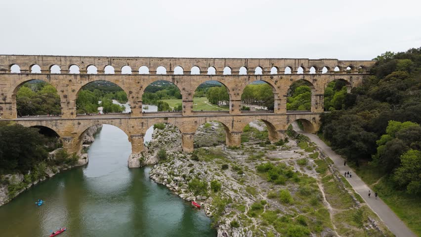 Stunning drone flight towards the ancient Pont du Gard, revealing its timeless beauty from above