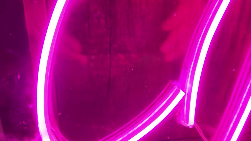 Pink neon led lights reflections on transparent plexiglass