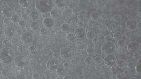 Macro shot of transparent bubbles forming a clean, shimmering texture in clear liquid. Elegant 4K footage perfect for science, cosmetics, spa, and minimal abstract backgrounds. - Powered by Shutterstock - Get 15% off with code: PIKWIZARD15