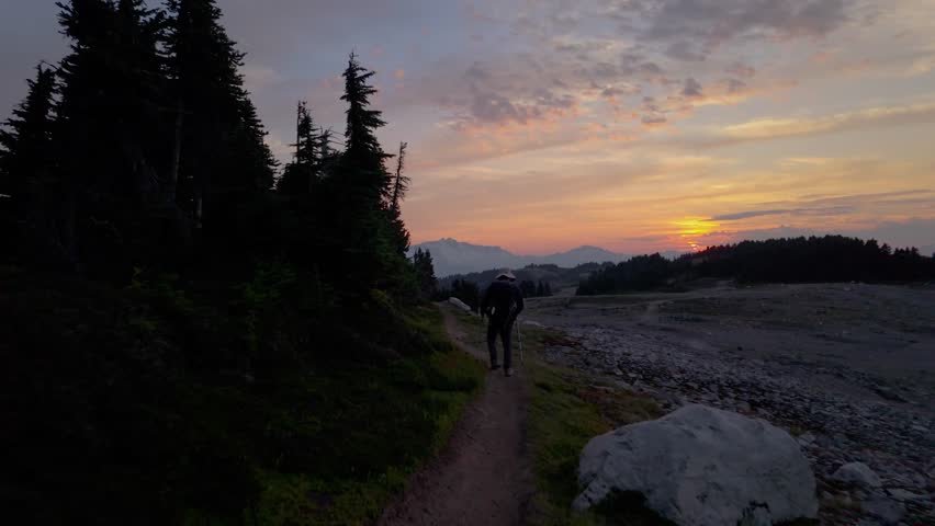 Hiker Walks Towards a Beautiful Mountain Sunset in Whistler, British Columbia, Canada