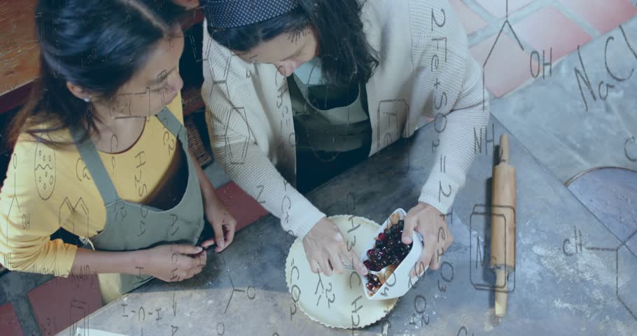 Two friends baking cherry pie lifting cherry compote dish and scooping filling onto pastry crust. Collaboration, baking, pastry, dessert, culinary, domestic, rustic