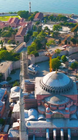 Vertical video. Istanbul, Turkey. Drone panorama of historic Fatih district with Hagia Sophia mosque and sea at sunrise. Aerial View, MasterShots, Spiral forward. Rich colors