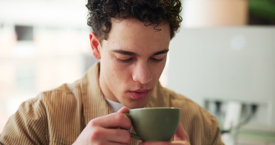 Coffee break, man and drink from cup in office, morning routine or boost energy for work day productivity. Caffeine fix, hot beverage or employee with latte in workplace, green tea or matcha to relax