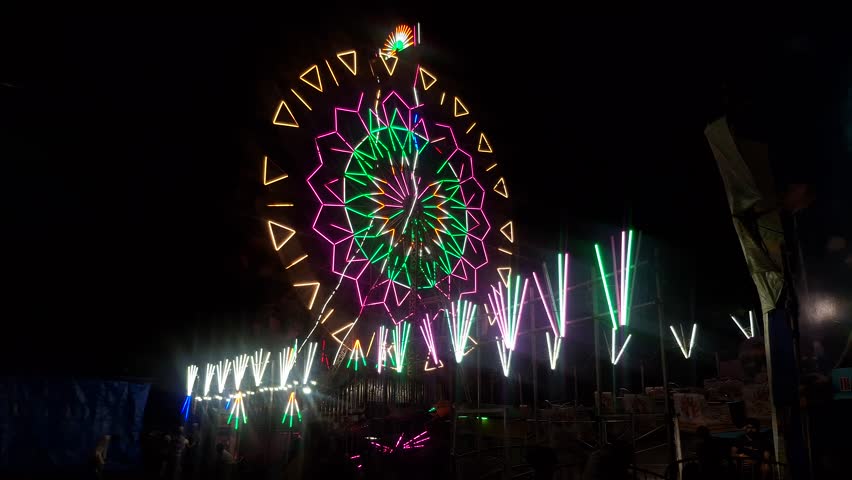 Ferris wheel glowing with colorful lights, creating a festive, joyful atmosphere, spinning gently under the night sky, perfect for celebrations