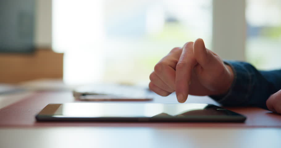 Hands, man and typing on tablet in office for article review, story editing and submission feedback. Publishing agency, editor and digital tech at for fact checking blog and proofreading publication