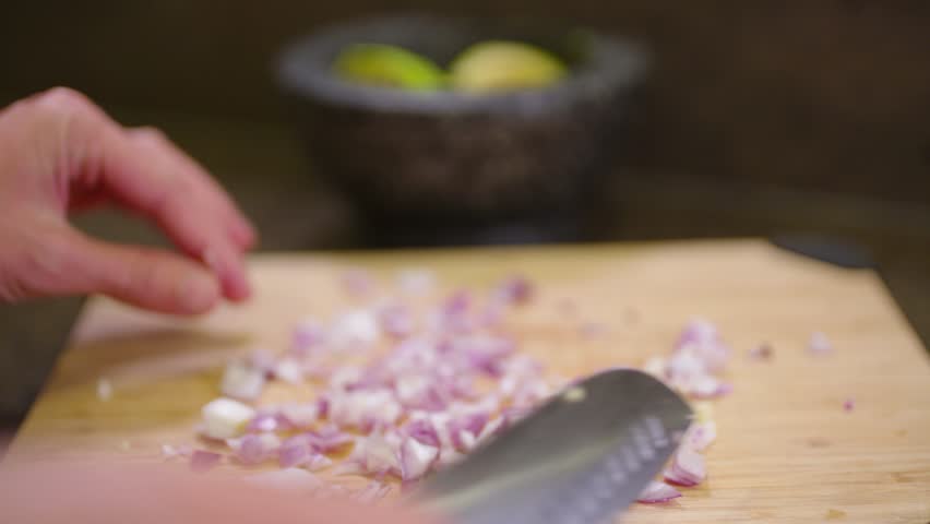 chopping red onions for fresh guacamole