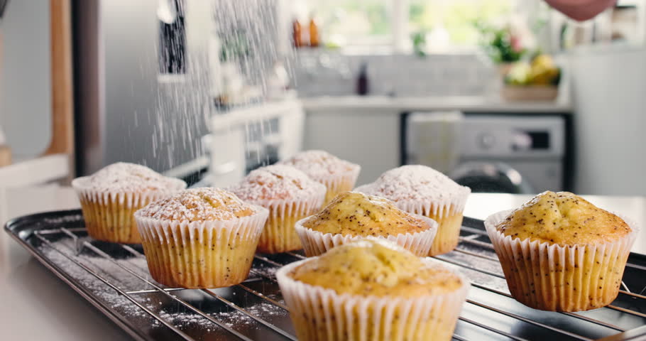 Homemade, muffin or sprinkle with icing sugar in kitchen, baked goods or fresh pastry for tea time snack. Confection, tray of cupcake and cover with powder for taste, sweet treat and dessert meal.