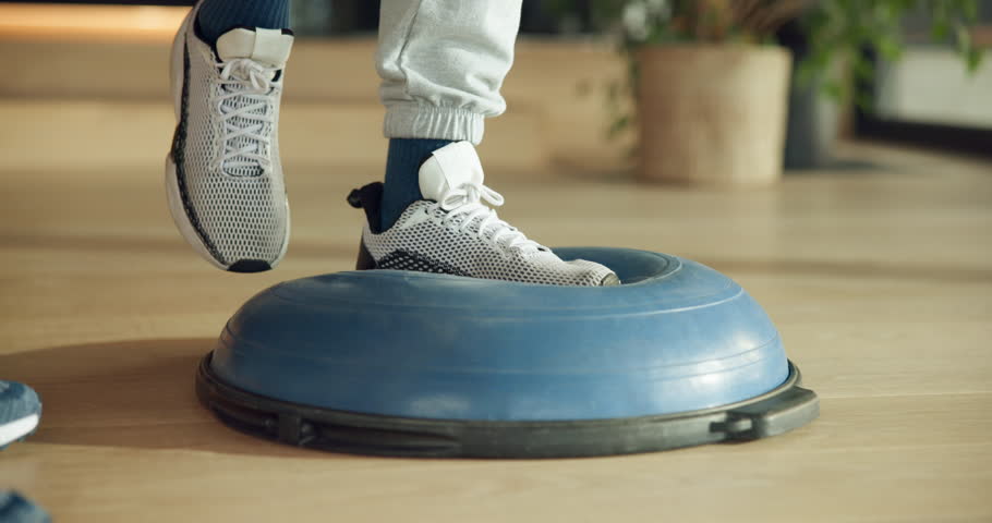 Physiotherapy, balance and feet of people on ball for muscle recovery, rehabilitation and injury healing. Sprain ankle treatment, healthcare and physical therapy with client and equipment for help