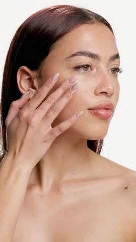 Beauty, woman and happy with face cream in studio for skincare routine, hydration and skin glow. Dermatology, person and smile with retinol product on white background for acne treatment or self care