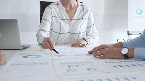 Team of business people examining financial reports, charts, and graphs during a strategy meeting. Concept of teamwork, corporate planning, and decision making - Powered by Shutterstock - Get 15% off with code: PIKWIZARD15