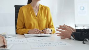 Business professionals discussing charts and graphs, analyzing data and collaborating on strategic project in modern corporate workspace - Powered by Shutterstock - Get 15% off with code: PIKWIZARD15