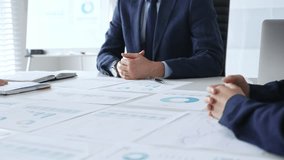 Business people shaking hands in office with financial charts, laptop and reports on desk top, symbolizing success, teamwork, agreement, collaboration and growth. Businesspeople handshake - Powered by Shutterstock - Get 15% off with code: PIKWIZARD15