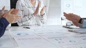 Business team clapping hands in meeting celebrating success with financial charts, data analysis, sales growth reports, and teamwork achievement in modern office - Powered by Shutterstock - Get 15% off with code: PIKWIZARD15