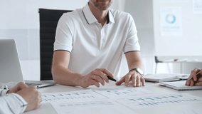 Professional business team reviewing financial data, collaborating over charts and graphs with laptop and pen in contemporary workplace, emphasizing strategic analysis and teamwork - Powered by Shutterstock - Get 15% off with code: PIKWIZARD15