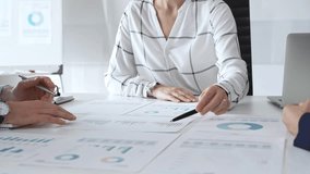 Team collaboration in modern office with financial documents, charts and graphs on desk, professionals discussing strategy, planning, and analysis during meeting. Diverse business people group at work - Powered by Shutterstock - Get 15% off with code: PIKWIZARD15