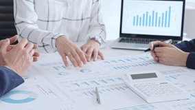 Business people professionals in a meeting analyze financial reports, charts and graphs on laptop and paper, using calculator to discuss strategy, budgeting and teamwork decisions - Powered by Shutterstock - Get 15% off with code: PIKWIZARD15