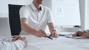 Professional business team reviewing financial data, collaborating over charts and graphs with laptop and pen in contemporary workplace, emphasizing strategic analysis and teamwork - Powered by Shutterstock - Get 15% off with code: PIKWIZARD15