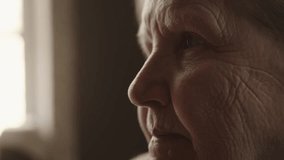 Closeup senior woman sitting indoor with soft window light - Powered by Shutterstock - Get 15% off with code: PIKWIZARD15