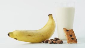 Milk banana Protein Bar and almonds on white background. Food meal energy breakfast, brunch snack. Healthy food contains nutrients protein, vitamins, calcium and benefits. Nutrition food isolated  - Powered by Shutterstock - Get 15% off with code: PIKWIZARD15