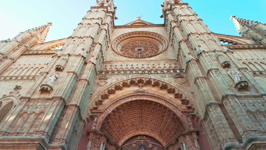 Beautiful facade of the Cathedral of Santa Maria of Palma in Palma de Mallorca, Balearic Islands, Spain. Impressive Gothic architecture with intricate stone carvings, a landmark of Majorca island