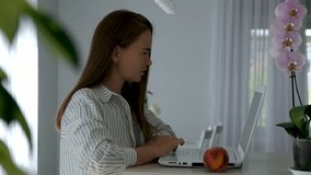 Young woman working from home on laptop, shout to family to give her time. Remote work stress, work-life balance challenge, multitasking at home, working mother, freelance lifestyle in cozy interior. - Powered by Shutterstock - Get 15% off with code: PIKWIZARD15