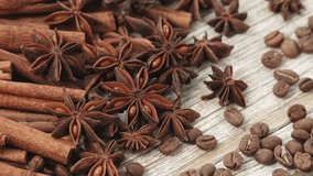 Christmas Aromatic Spices with Cinnamon, Star Anise and Coffee Beans Rotating on Wooden Table Creating Warm Festive Holiday Mood - Powered by Shutterstock - Get 15% off with code: PIKWIZARD15